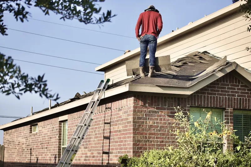 Professional roofer working on a residential roof in South Londonderry